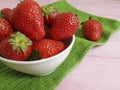 Fresh berry organic strawberry natural summer dish towel on a pink wooden background Royalty Free Stock Photo