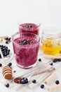 Fresh berry smoothie, milkshake, yogurt, dessert decorated grated chocolate, honey and blueberry Royalty Free Stock Photo