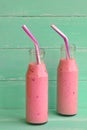 Fresh berry smoothies on mason jars with a straw. Vegetarian food concept Royalty Free Stock Photo