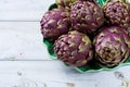 Fresh big Romanesco artichokes green-purple flower heads ready t Royalty Free Stock Photo