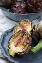 Fresh big Romanesco artichokes green-purple flower heads ready t Royalty Free Stock Photo