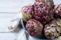 Fresh big Romanesco artichokes green-purple flower heads ready t Royalty Free Stock Photo