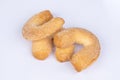 Fresh biscuit cookies in the form of bagels, sprinkled with sugar, on a white background