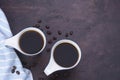 Fresh black coffee, a needle in a white coffee cup and fragrant roasted coffee beans, placed on a dark table Espresso coffee - Top Royalty Free Stock Photo