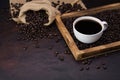 Fresh black coffee, a needle in a White coffee cup and fragrant roasted coffee beans, placed on a dark table Espresso coffee - Top Royalty Free Stock Photo