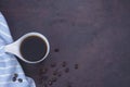 Fresh black coffee, a needle in a white coffee cup and fragrant roasted coffee beans, placed on a dark table Espresso coffee - Top Royalty Free Stock Photo