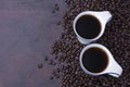 Fresh black coffee, a needle in a white coffee cup and fragrant roasted coffee beans, placed on a dark table Espresso coffee - Top Royalty Free Stock Photo