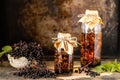 Fresh black elderberry syrup in a glass bottle on a wooden table. Copy space Royalty Free Stock Photo