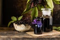 Fresh black elderberry syrup in a glass bottle on a wooden table. Copy space Royalty Free Stock Photo