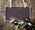 Fresh black olives and a blank slate Royalty Free Stock Photo