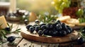 Fresh black olives on olive tree branches displayed on a wooden table in natural light Royalty Free Stock Photo