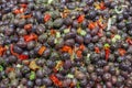 Fresh black olives, with spicy red pepper and parsley on sell in