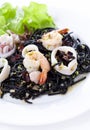 Fresh black tagliolini pasta with seafood in herbs Royalty Free Stock Photo