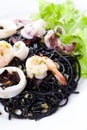 Fresh black tagliolini pasta with seafood in herbs Royalty Free Stock Photo