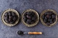 Fresh blackberry on plate and spoon on dark stone background. To Royalty Free Stock Photo