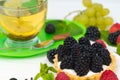 Fresh blackberry tart with spicy lemon tea Royalty Free Stock Photo