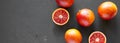 Fresh blood oranges on a black surface, top view. Flat lay, overhead, from above. Copy space Royalty Free Stock Photo