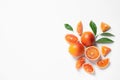 Fresh bloody oranges and leaves on white background, top view.