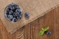 Fresh blueberries on a background of burlap planks Royalty Free Stock Photo