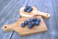 Fresh blueberries on bamboo cutting board. Royalty Free Stock Photo