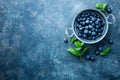 Fresh Blueberries in a bowl on dark background, top view. Juicy wild forest berries, bilberries Royalty Free Stock Photo