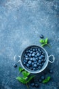 Fresh Blueberries in a bowl on dark background, top view. Juicy wild forest berries, bilberries Royalty Free Stock Photo