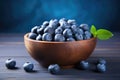 Fresh blueberries in bowl on wooden background. Blueberry antioxidant, Fresh blueberries in wooden bowl on blue wooden table,