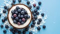 Fresh Blueberries in Coconut Shell on Blue Background Royalty Free Stock Photo