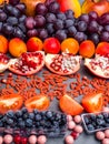 Fresh blueberries, cranberrys, apricots, apples, tomatoes, pomegranate, grape mix of fruit, flat lay, rich in resveratrol,