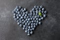 Fresh blueberries heart shape on black background