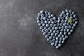 Fresh blueberries heart shape on black background