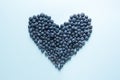 Fresh blueberries layed in shape of heart Royalty Free Stock Photo