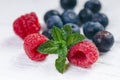 Fresh blueberries with mint on a wooden white table. Natural antioxidant. Concept of healthy food. Organic superfood Royalty Free Stock Photo