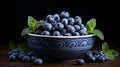 Fresh blueberries and spearmint in clay bowl on rustic wooden table for healthy eating and cooking