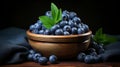 Fresh blueberries and spearmint in clay bowl on wooden table, rustic harvest scene