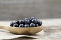 Fresh blueberries in spoon on wooden background Royalty Free Stock Photo