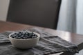 Fresh blueberries in white bowl on wood table Royalty Free Stock Photo
