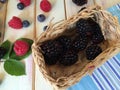 Fresh blueberries on white plate and blue kitchen cloth