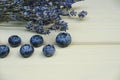 Fresh blueberries on a wooden board, dark background. Lavender. Vertical photo.