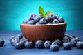 Fresh blueberries in wooden bowl on blue wooden background. Blueberry antioxidant, Fresh blueberries in wooden bowl on blue wooden