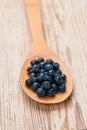 Fresh blueberries in wooden spoon on white vintage background. Healthy eating Royalty Free Stock Photo