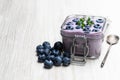 Fresh blueberries yogurt in glass jar on white wooden table Royalty Free Stock Photo