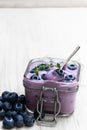 Fresh blueberries yogurt in glass jar on white wooden table Royalty Free Stock Photo