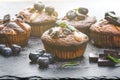 Fresh, blueberry muffins on a stone background with sugar and fruits. Food background. Concept of pastry. Royalty Free Stock Photo