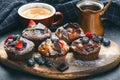 Fresh, blueberry muffins on a stone background with sugar and fruits. Food background. Concept of pastry. Royalty Free Stock Photo