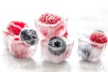 Fresh blueberry and raspberry in ice on table background Royalty Free Stock Photo