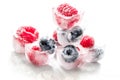 Fresh blueberry and raspberry in ice on table background Royalty Free Stock Photo