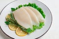 Fresh body, squid, raw, three carcasses, top view, no people , on a plate,