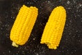 Fresh boiled cob corn on a dark wooden board with salt Royalty Free Stock Photo