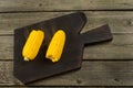 Fresh boiled cob corn on a dark wooden board with salt Royalty Free Stock Photo